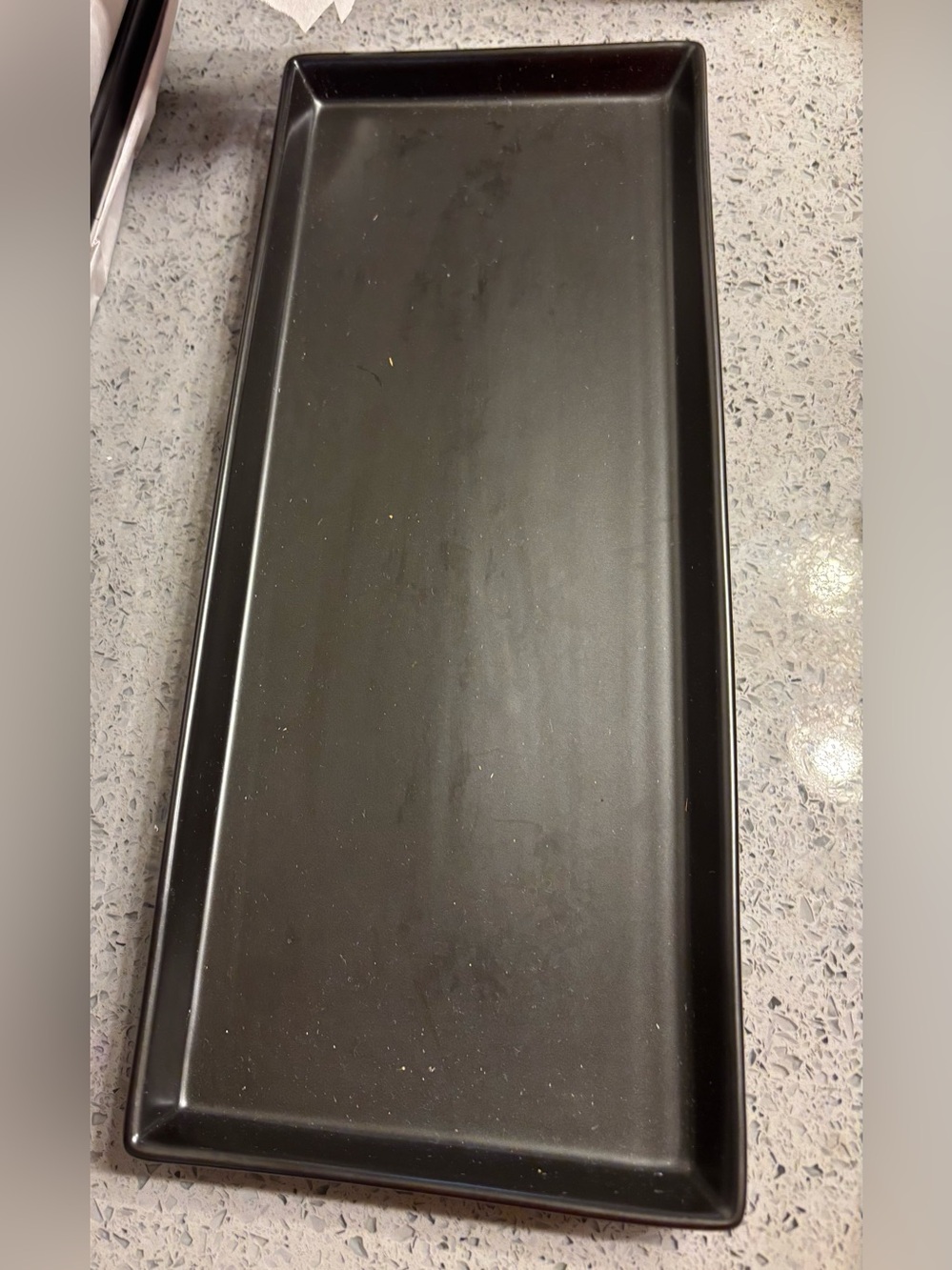 Black rectangular ceramic vanity and serving tray with a smooth finish